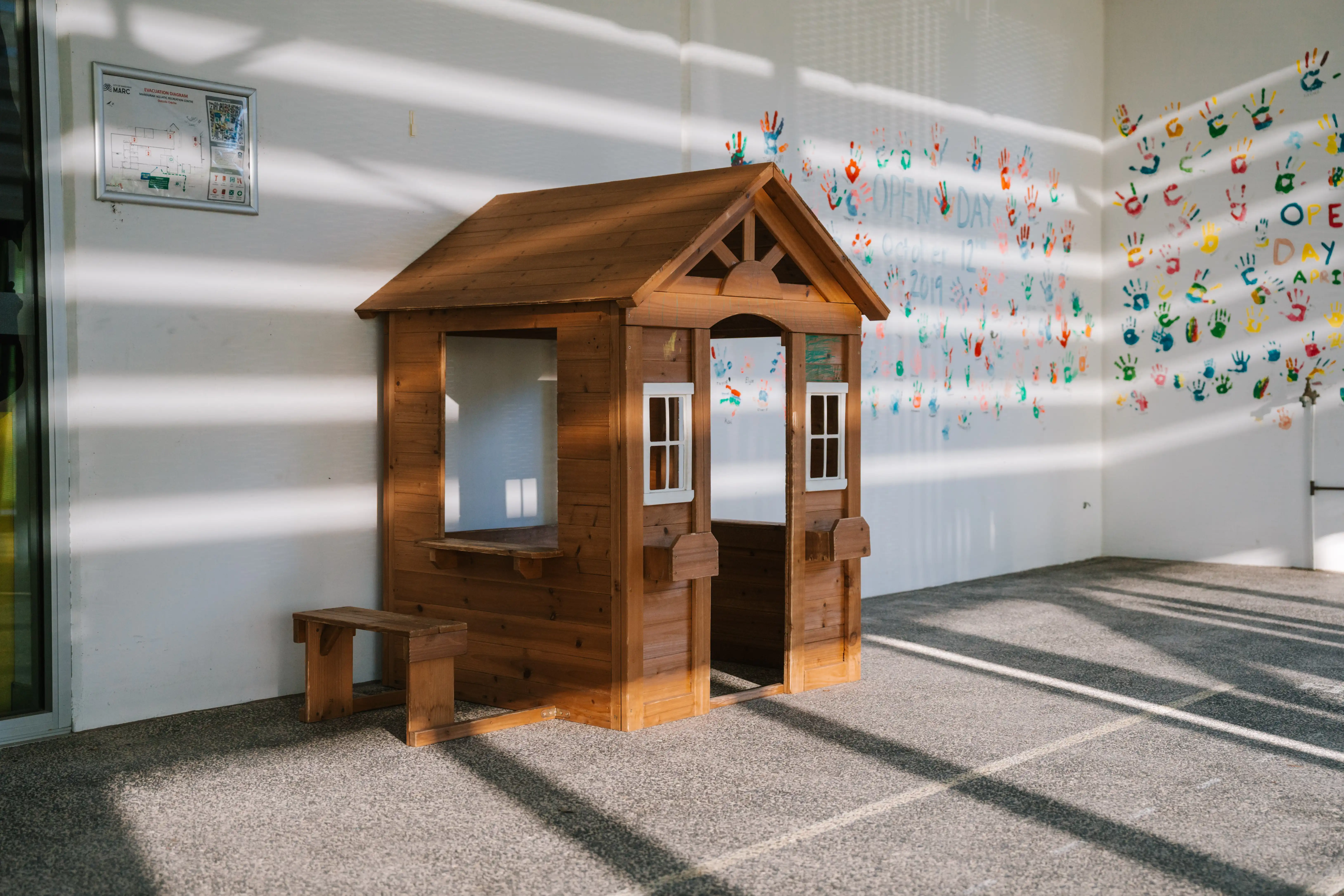 Wooden cubby house in the outdoor play area at the MARC crèche